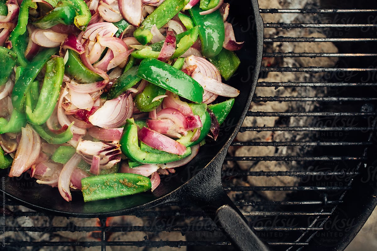 Peppers and onions for fajitas in a cast iron skillet