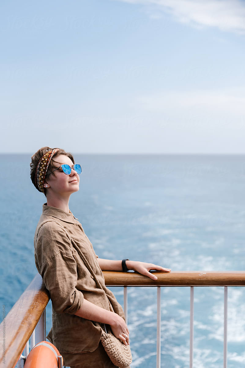 Beautiful brunette woman relaxing in sea trip on ship.