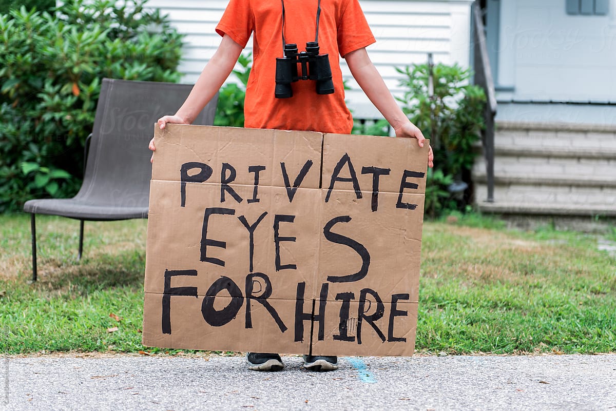 Child holds handmade Private Eyes for Hire sign