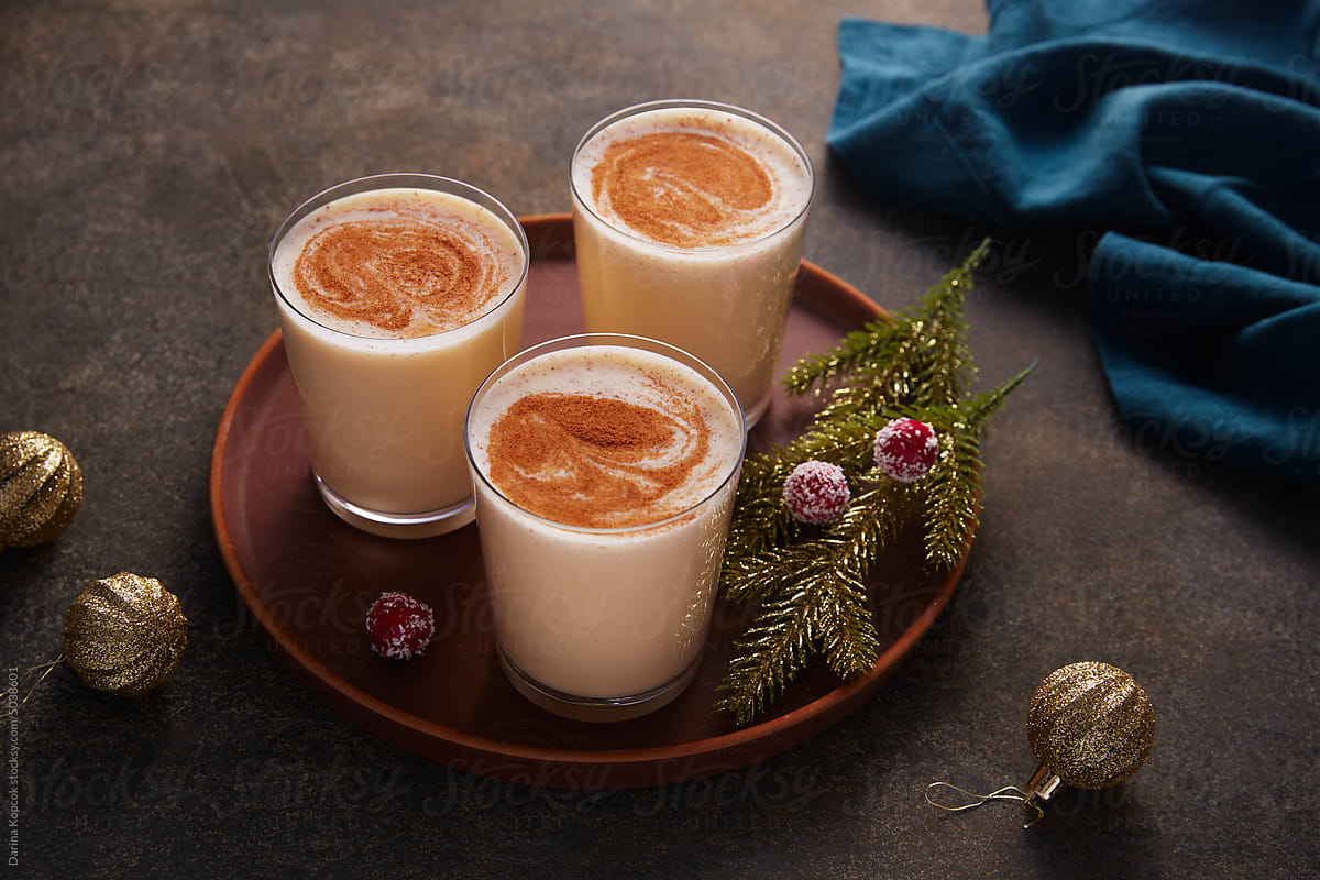 Glasses Of Eggnog On A Tray With Holiday Decorations by Stocksy  Contributor Darina Kopcok - Stocksy