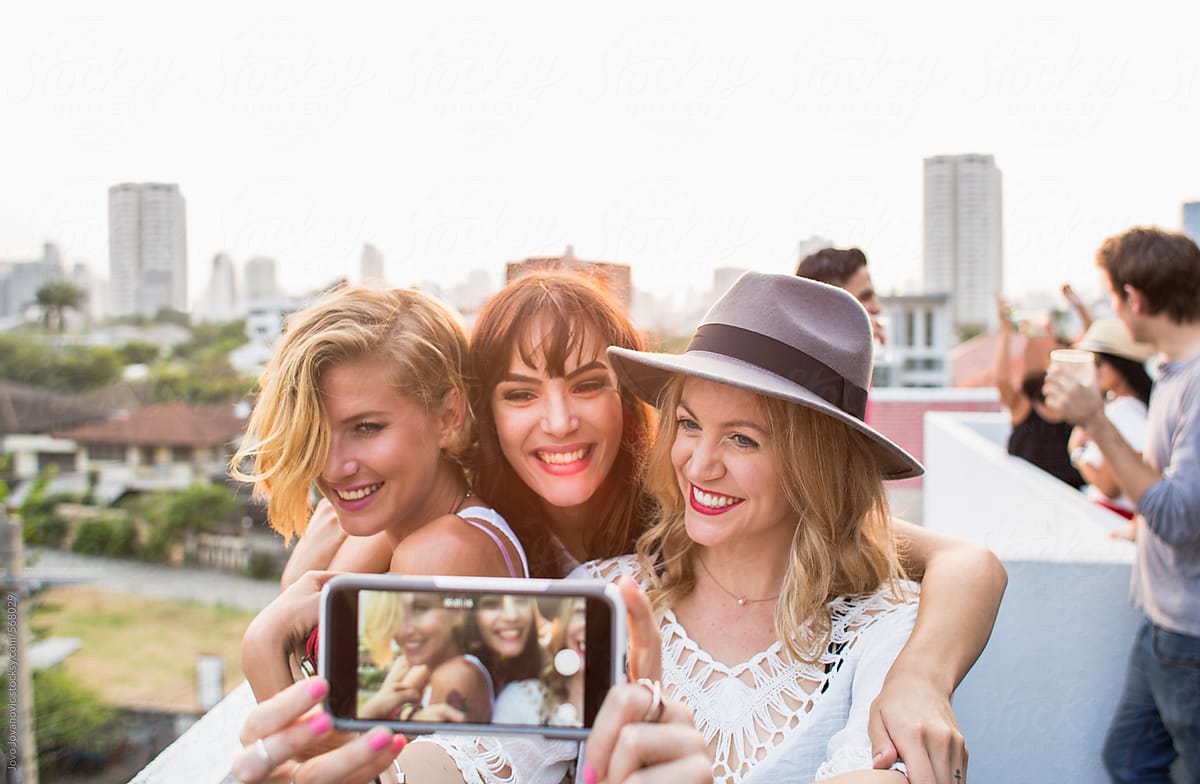 Three Girlfriends Taking A Selfie At A Party By Stocksy Contributor 
