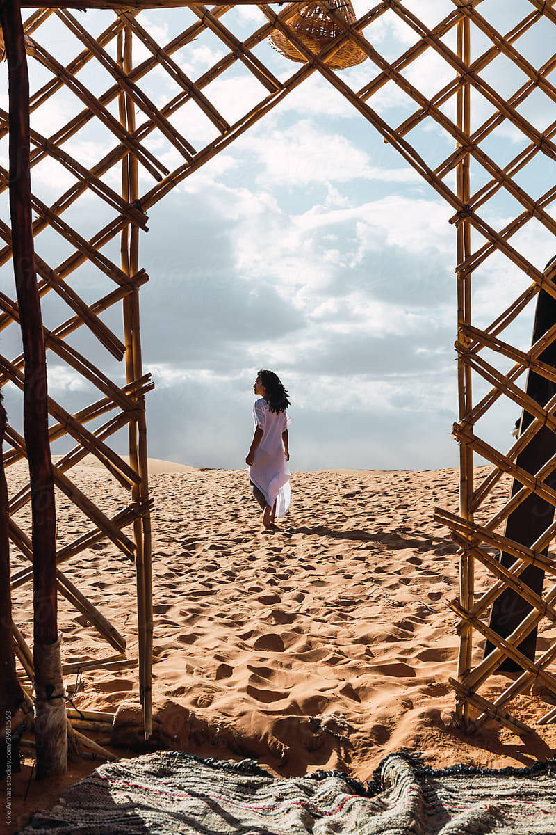Ethnic woman walking in the desert.