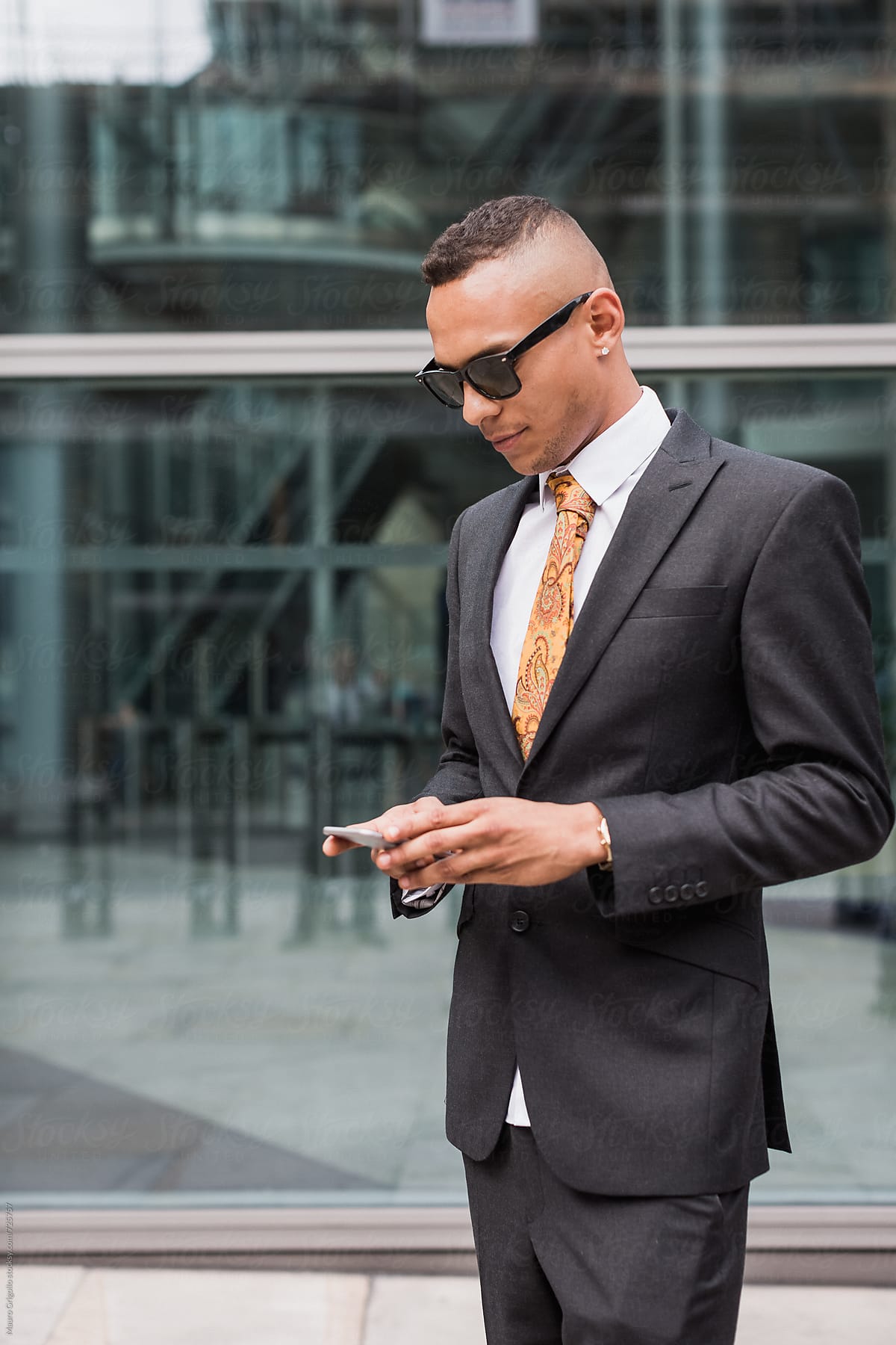 Cool Businessman using mobile phone for social media