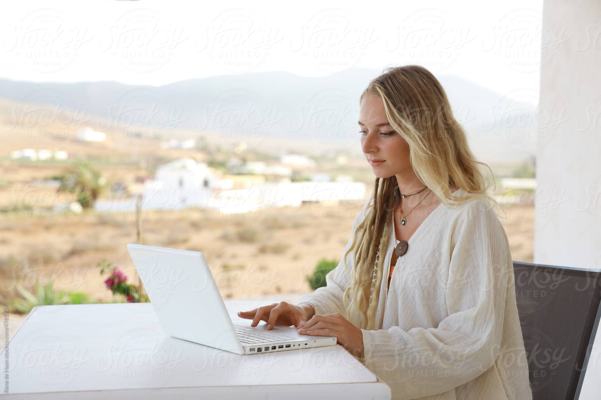 blonde female typing on laptop