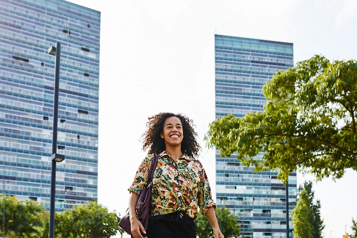 Happy businesswoman walking in city centre
