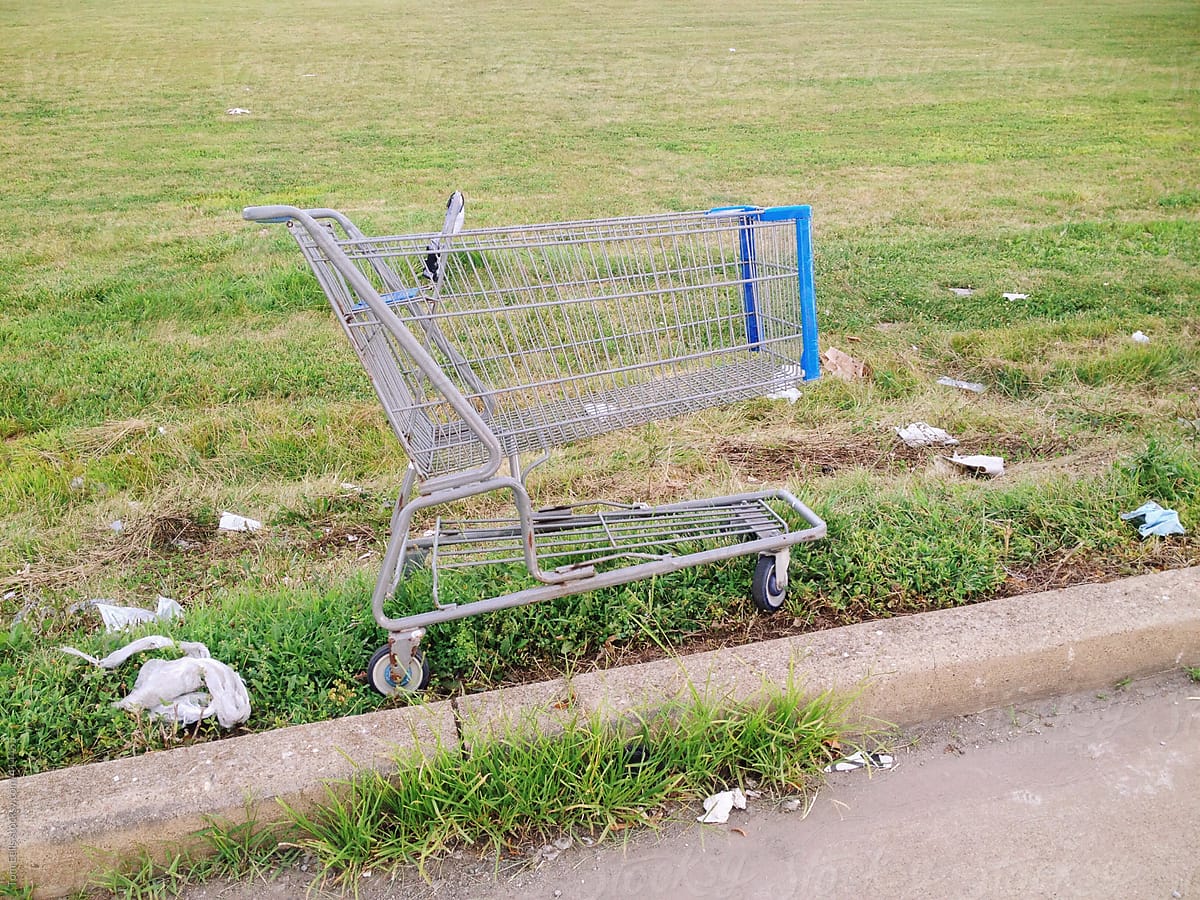 Abandoned shopping cart in a rough lot