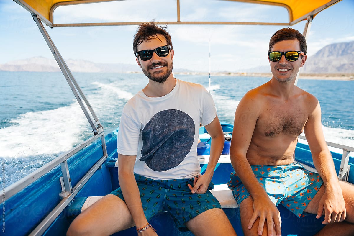 Two men traveling on boat along sea.