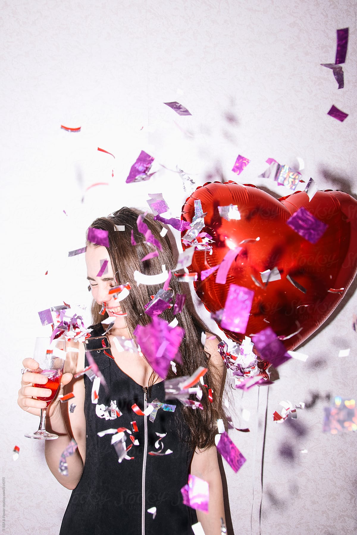 Young Woman Holding Heart Balloon And Glass Of Champagne Del Colaborador De Stocksy Danil 