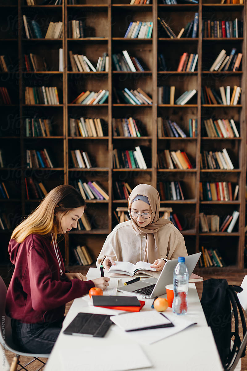 Islamic students doing homework in library