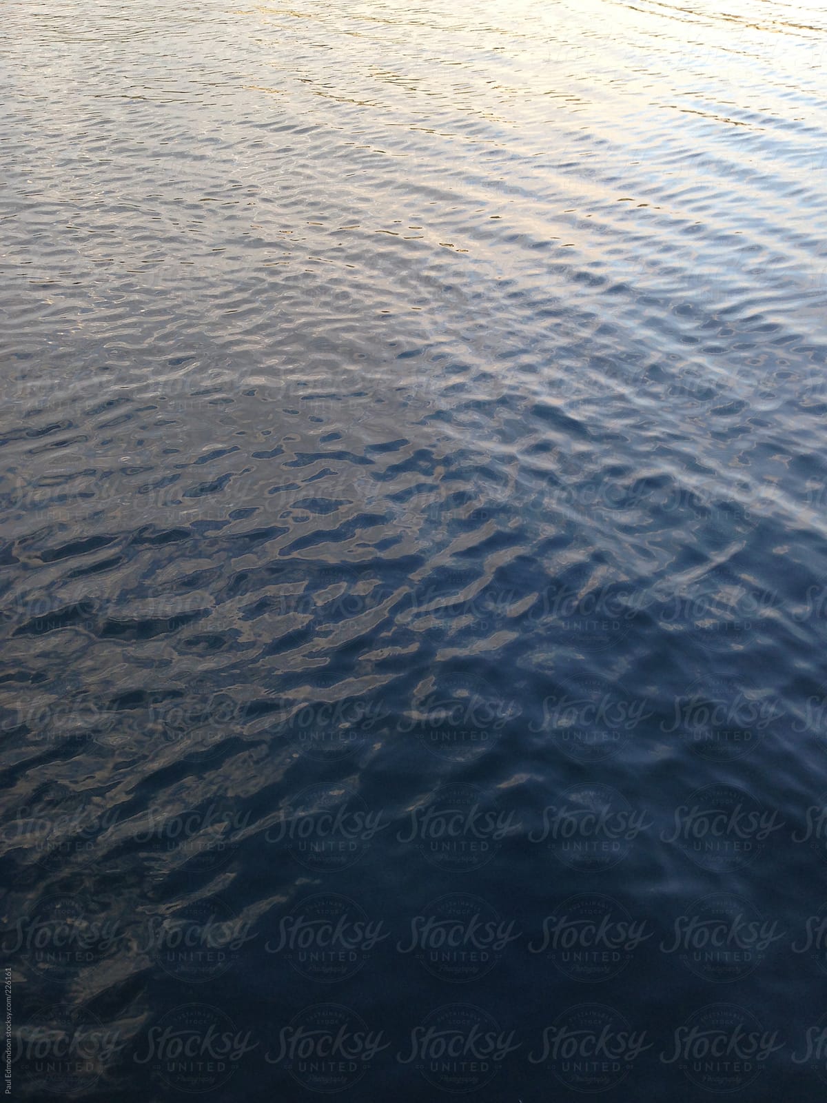 Reflections and ripples on ocean water, dusk