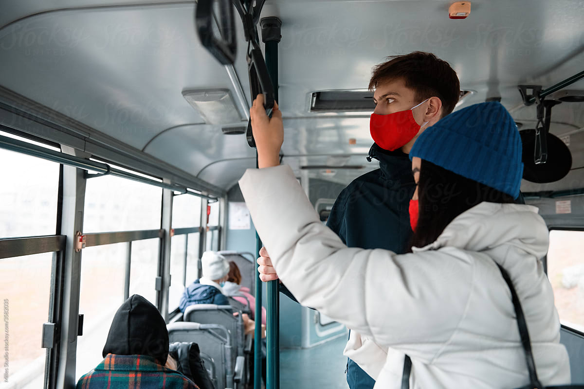 Diverse friends riding bus during pandemic