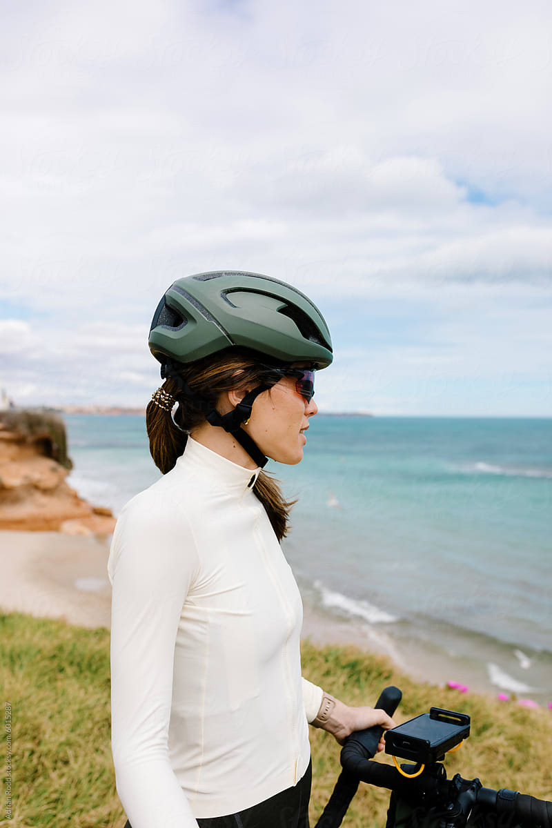 Medium shot portrait of a sporty woman dressed in a cycling jersey