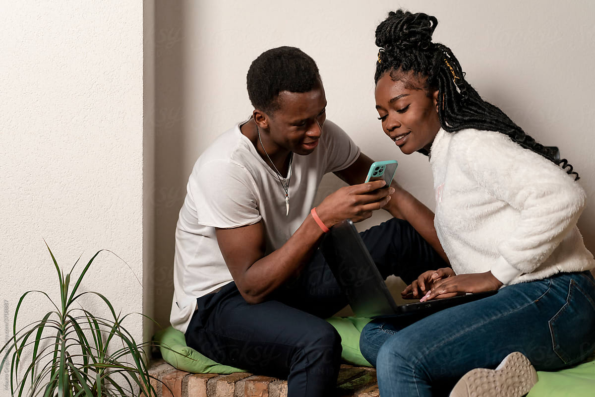 Black Couple using technology At Home