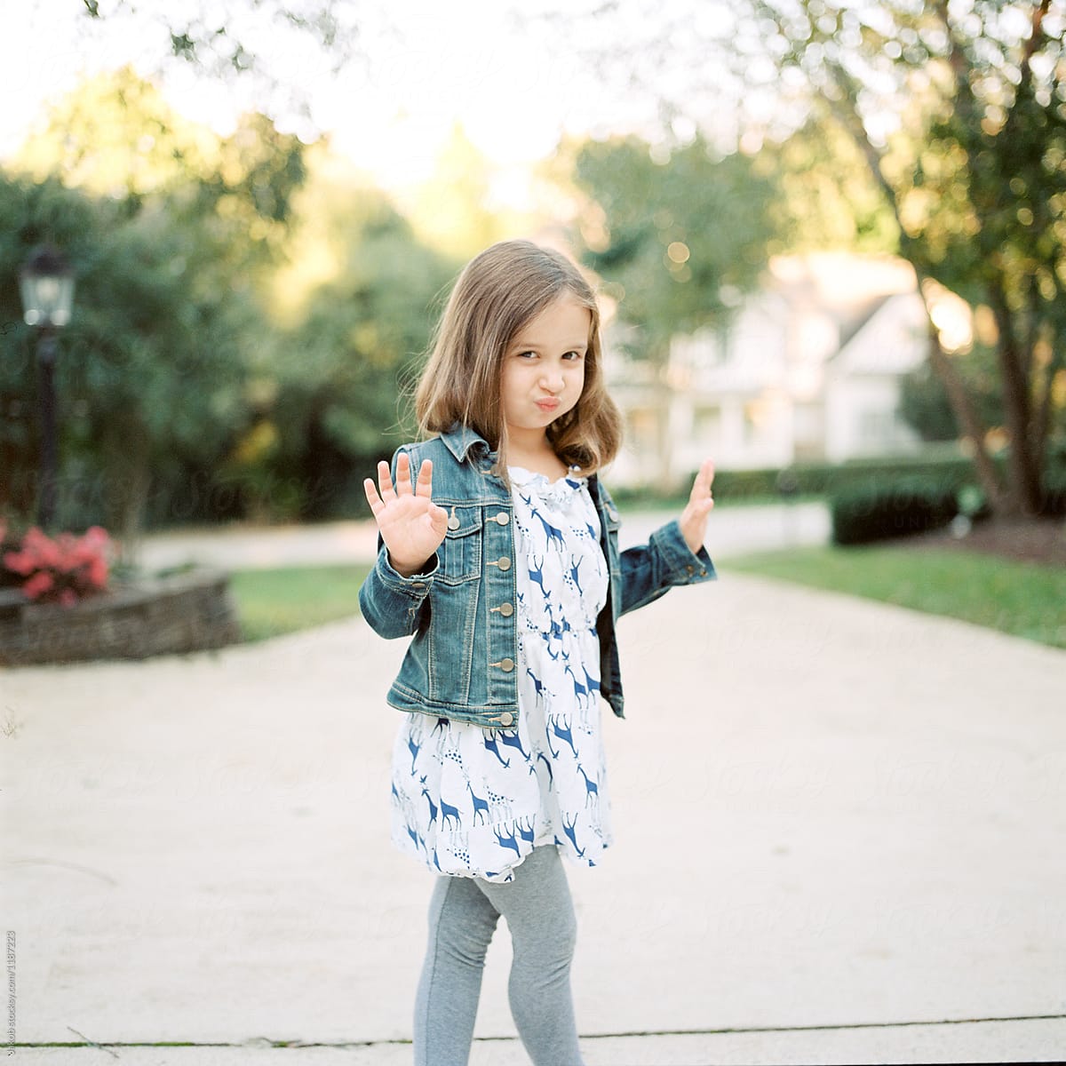 Cute Young Girl In A Dress And Denim Jacket Acting Sassy By Stocksy 