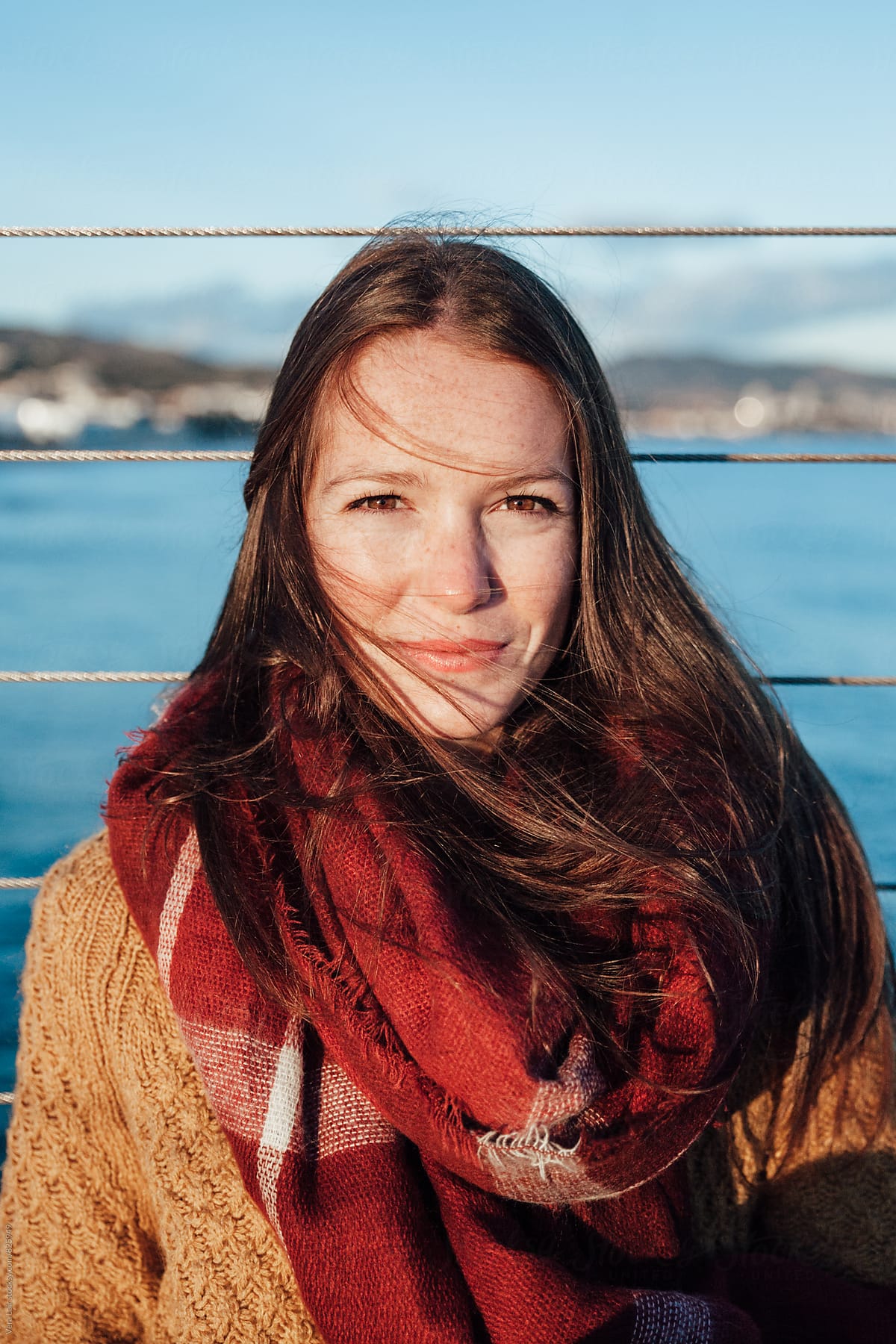 Portrait Of Young Woman With Freckles Looking At Camera By Stocksy