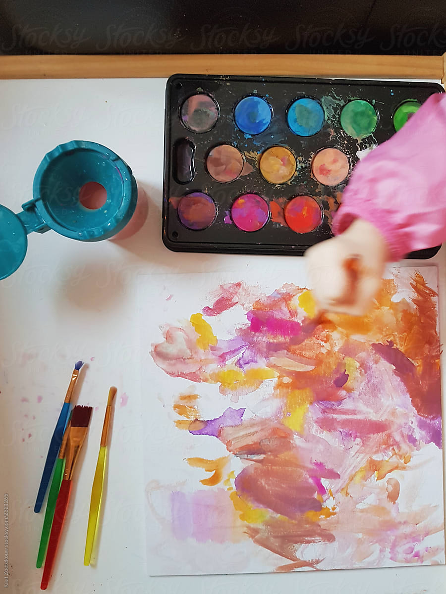 A toddler watercolors