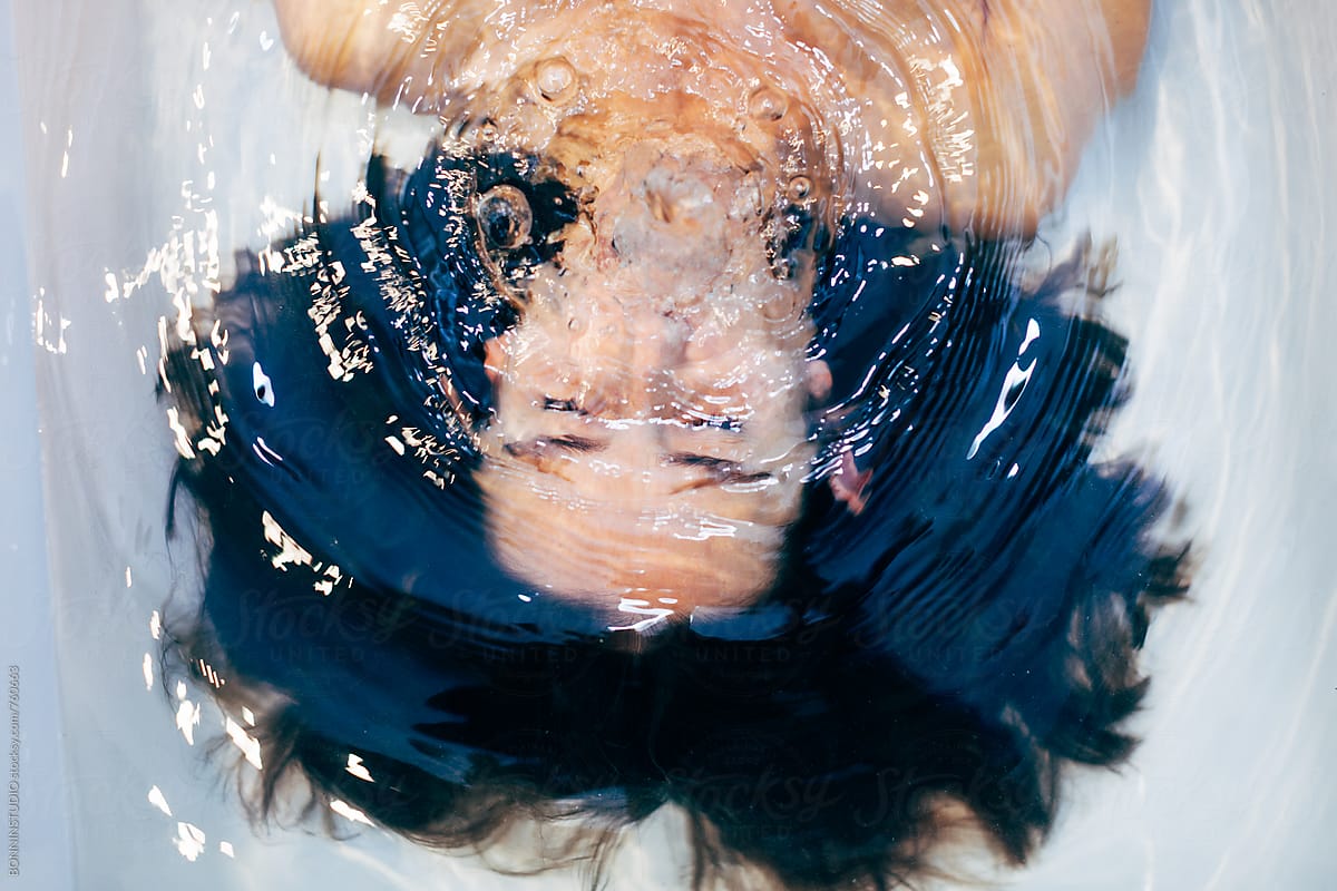 Woman Holding Breath Underwater In The Bathtub.