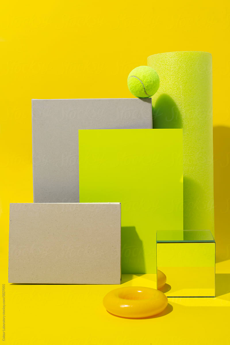 Bright neon yellow still life image of geometric objects of materials