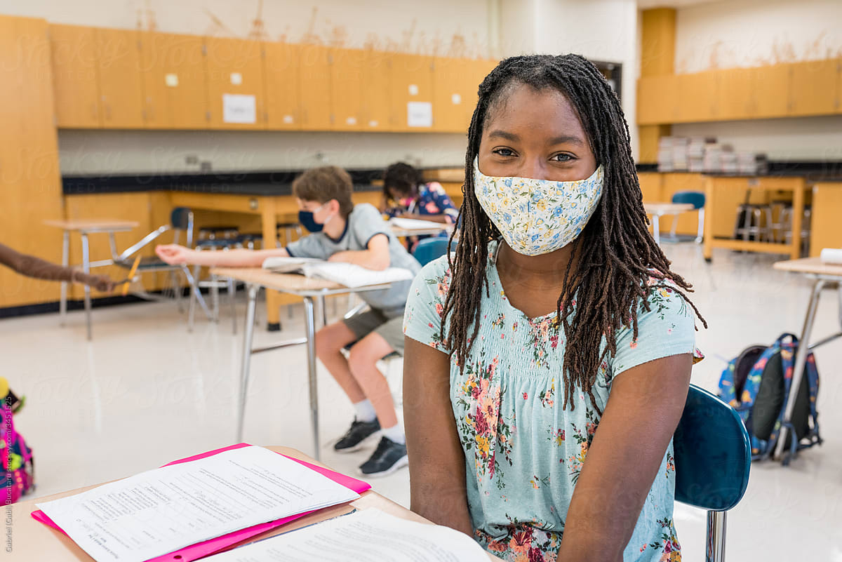 Cute black girl with mask in school during COVID-19