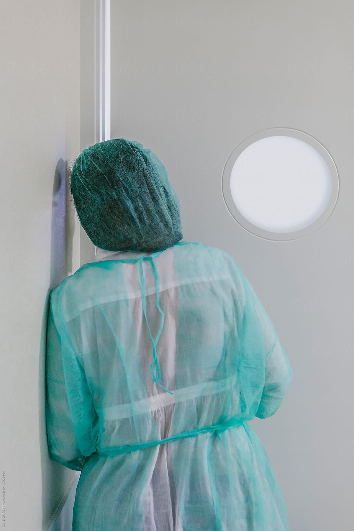 Woman Looking Behind a Hospital Door