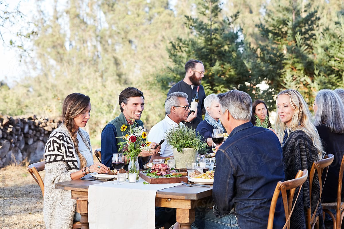 Outdoor dinner party with friends and family food wine