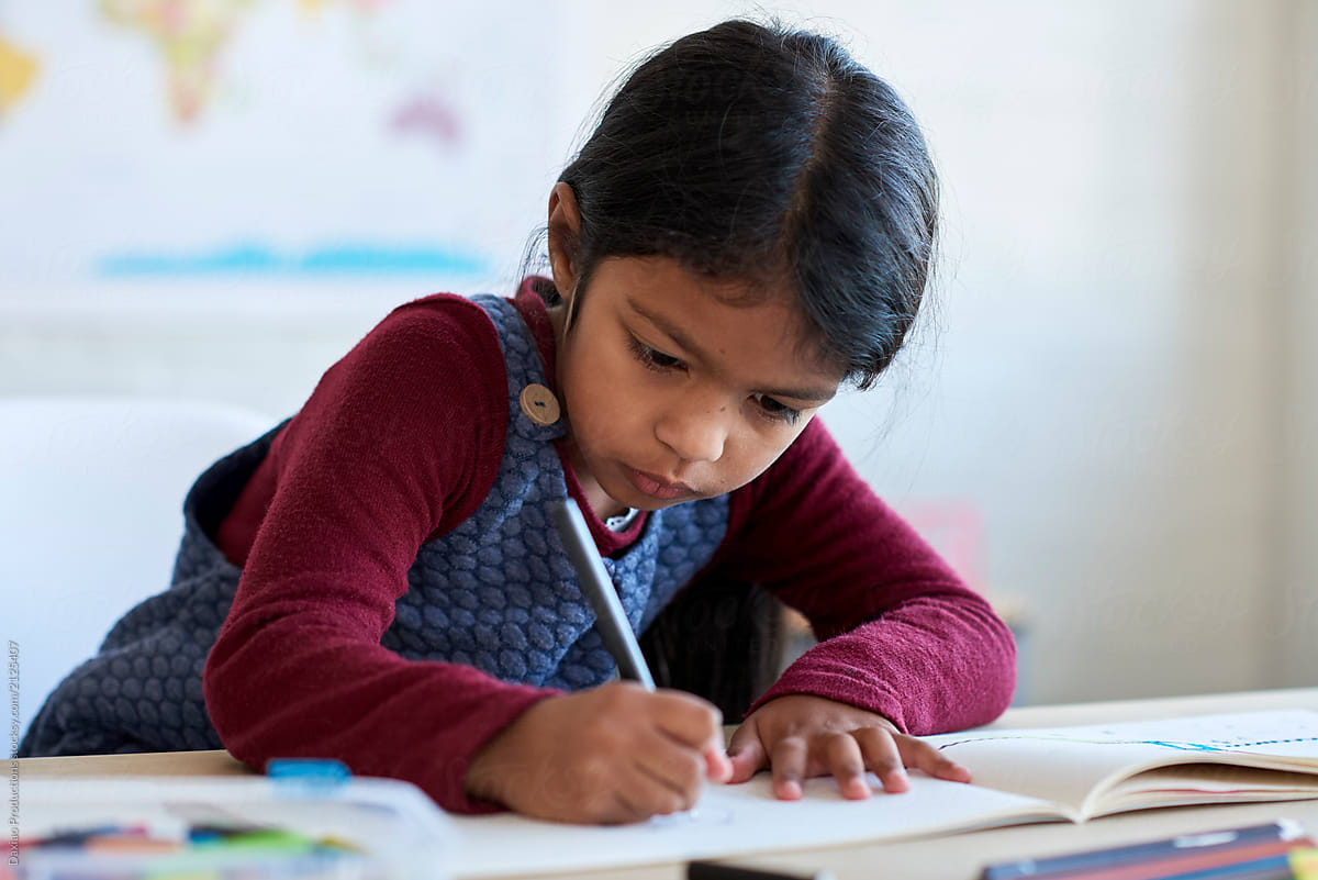Young indian girl concentrating on her school work