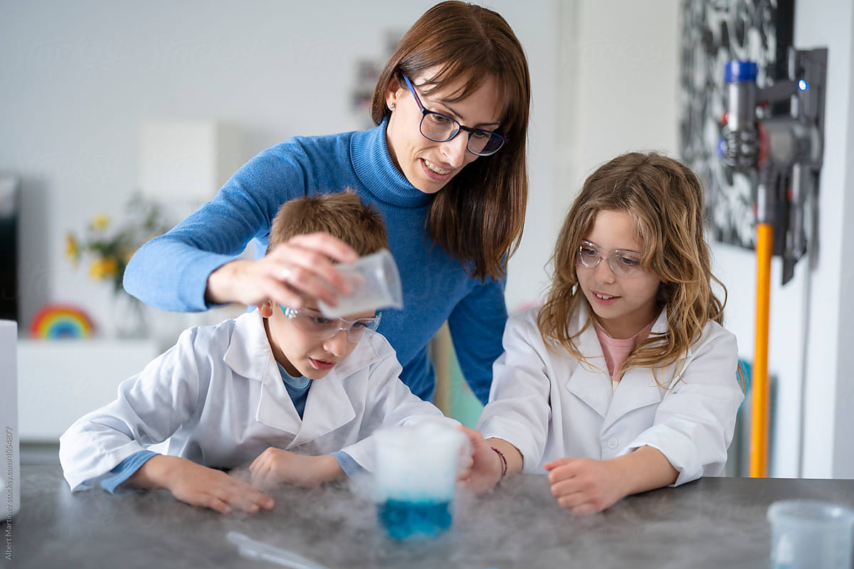 Children and mother performing a chemical experiment
