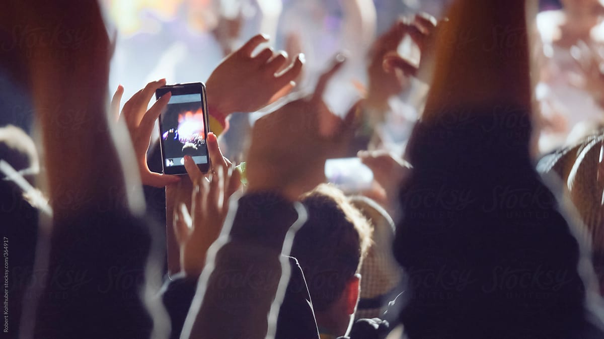 Making video with cell phone at live music concert, festival