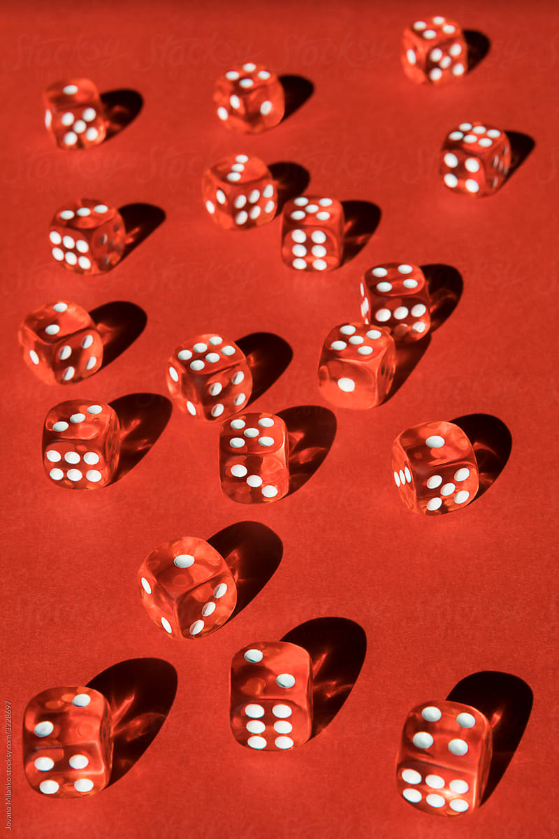 Many transparent red dice on red background