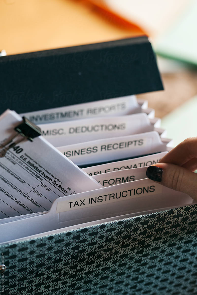Taxes: Woman Pulling 1040 Tax Form From Folder