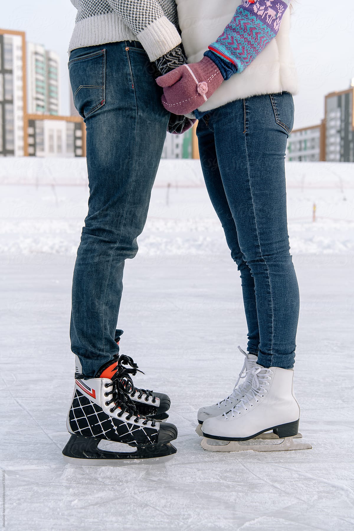Crop couple on skating rink