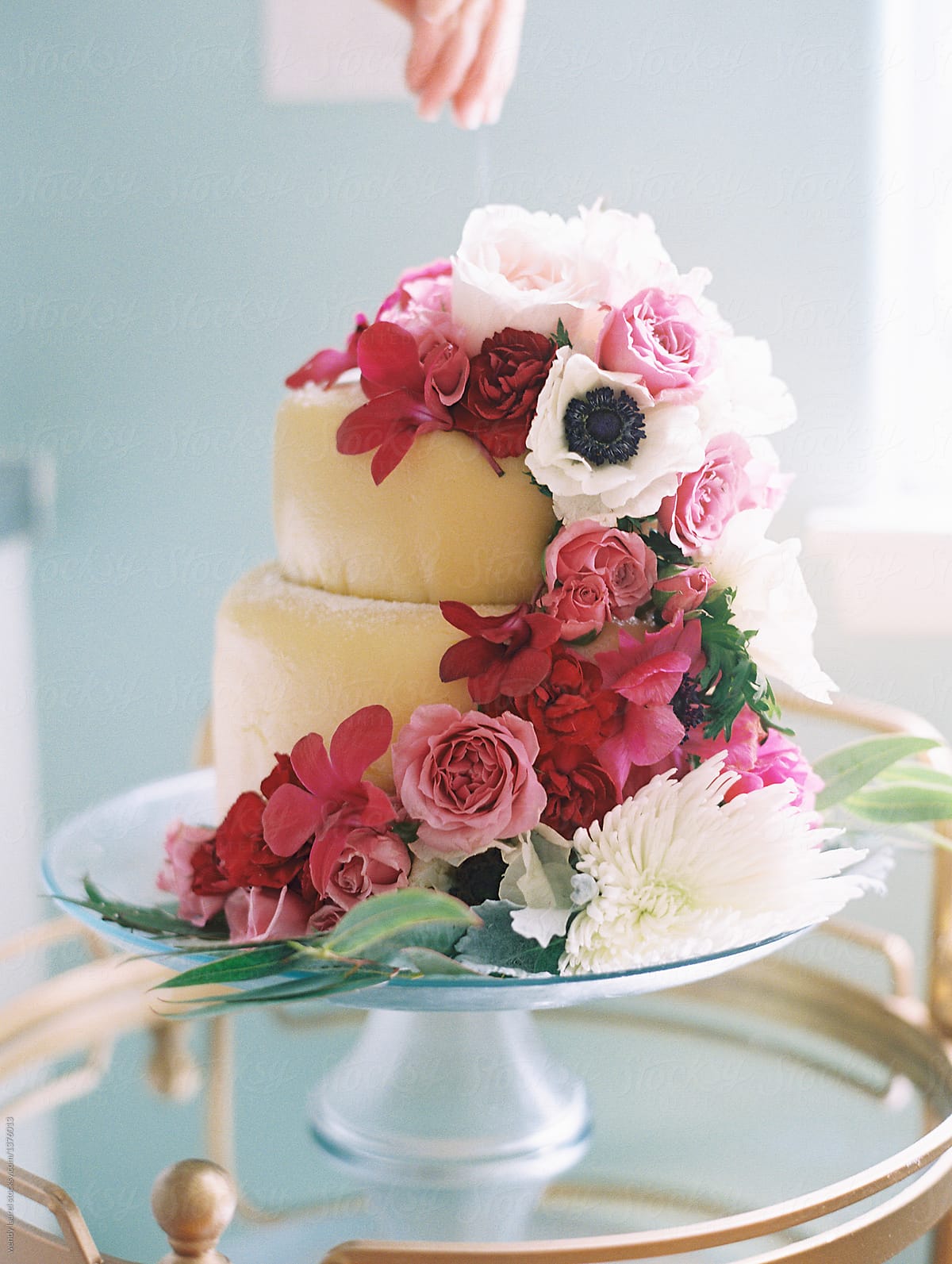 wedding cake with bright pink and red flowers