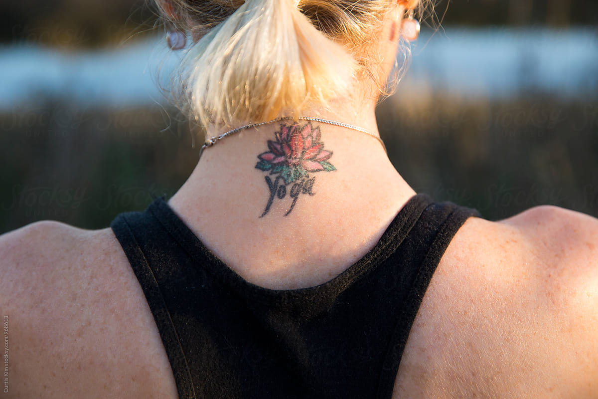 Blonde woman with tattoo on the back of her neck