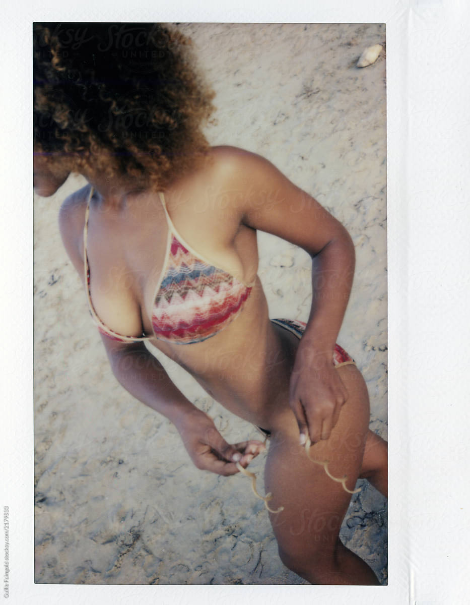 Instant Shot Of Woman Taking Off Bikini by Stocksy Contributor Guille  Faingold - Stocksy