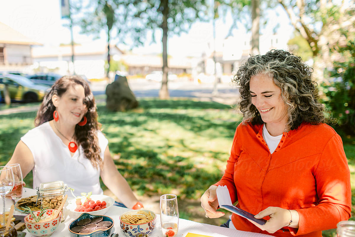 Smiling women enjoying picnic together