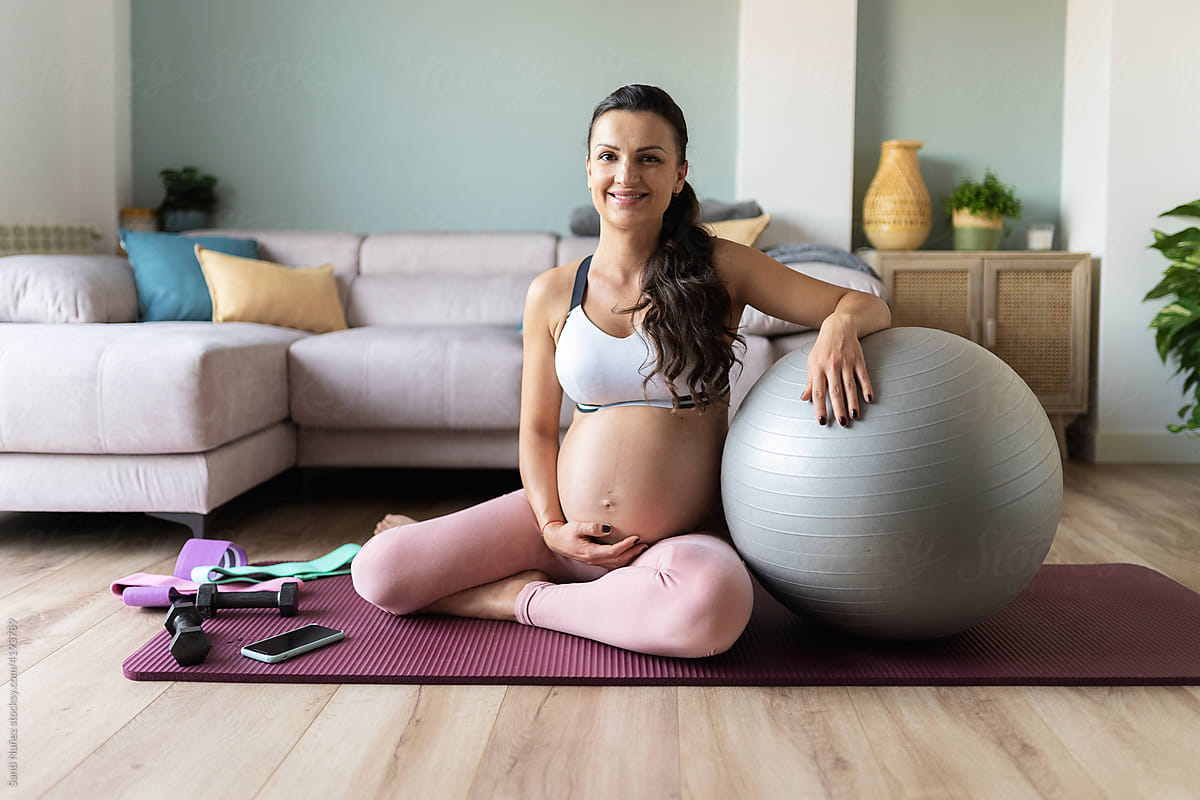 Portrait of smiling pregnant woman at home.