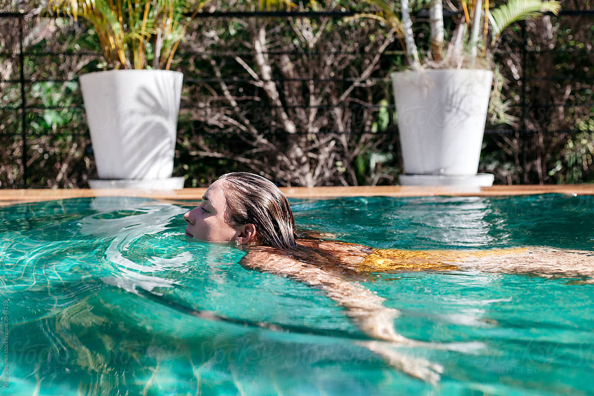 Woman swimming in clean pool water