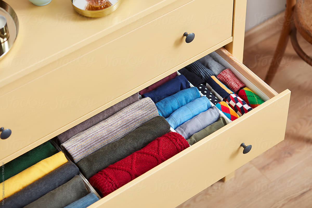 Neatly Folded Clothes In Wardrobe By Marti Sans Stocksy United