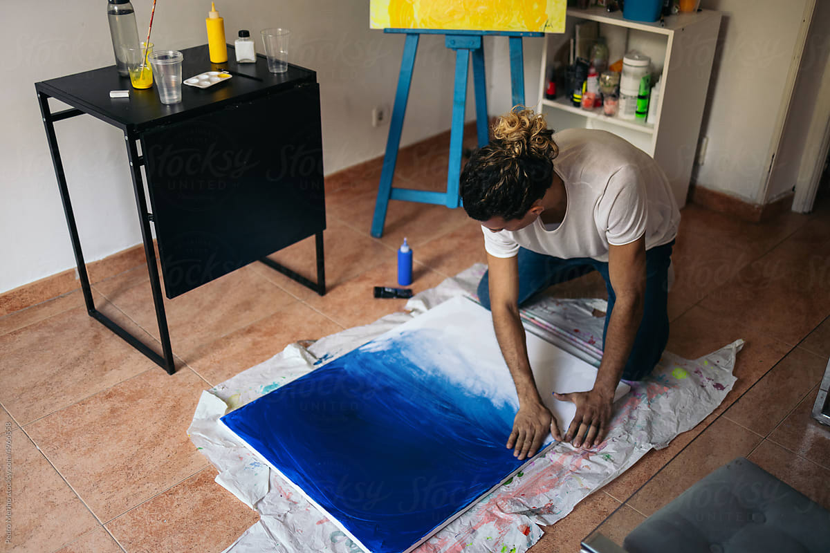 Artist painting a canvas with innovative methods