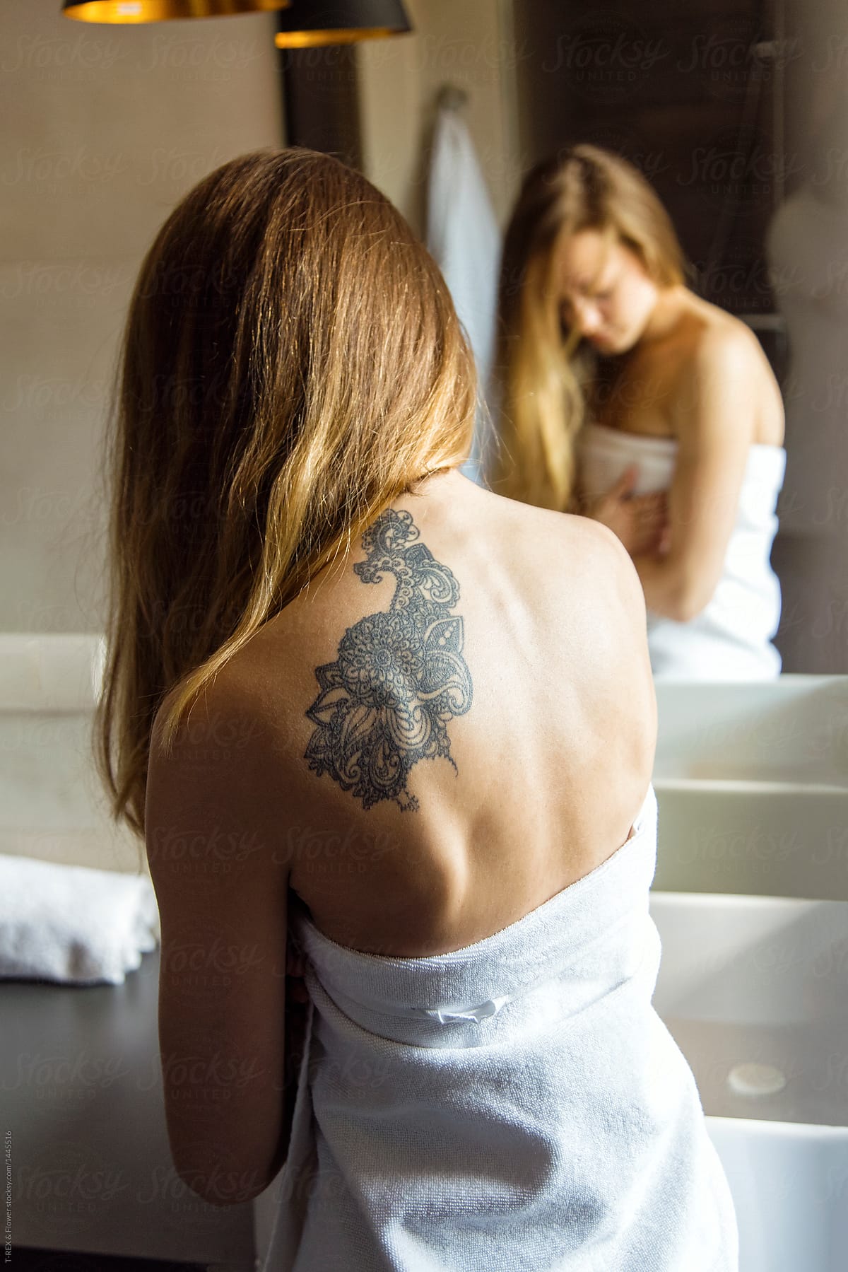 Tattooed woman in towel