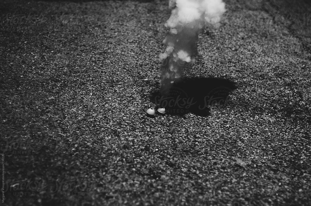 two smoke bombs in an alley