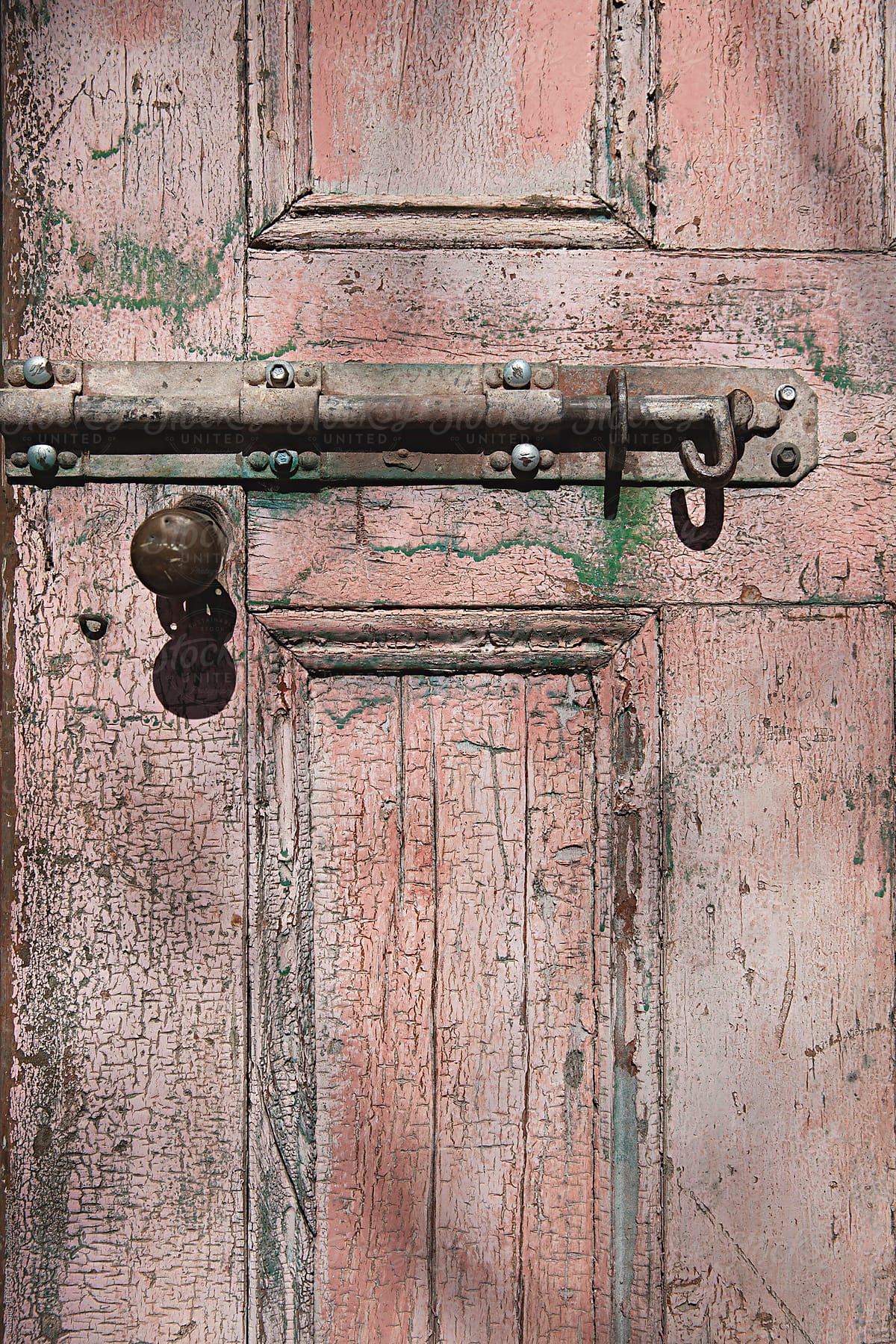 close up of old weathered door, handle and lock