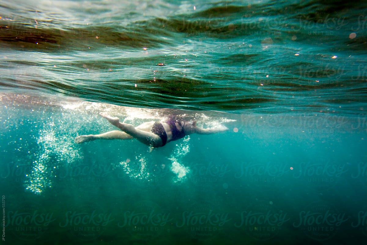 Woman Swimming Freestyle Triathlon Training In Clear Blue Lake