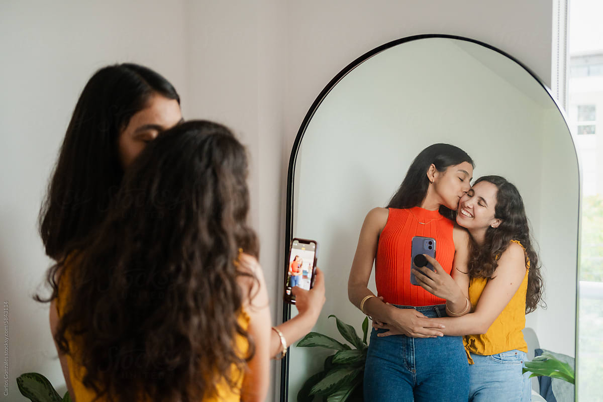 Young Lesbian Couple Taking a Selfie in the Mirror