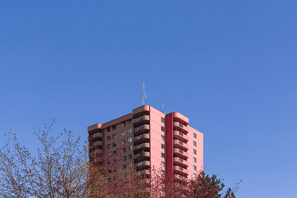 Pink building with a trees in front of it