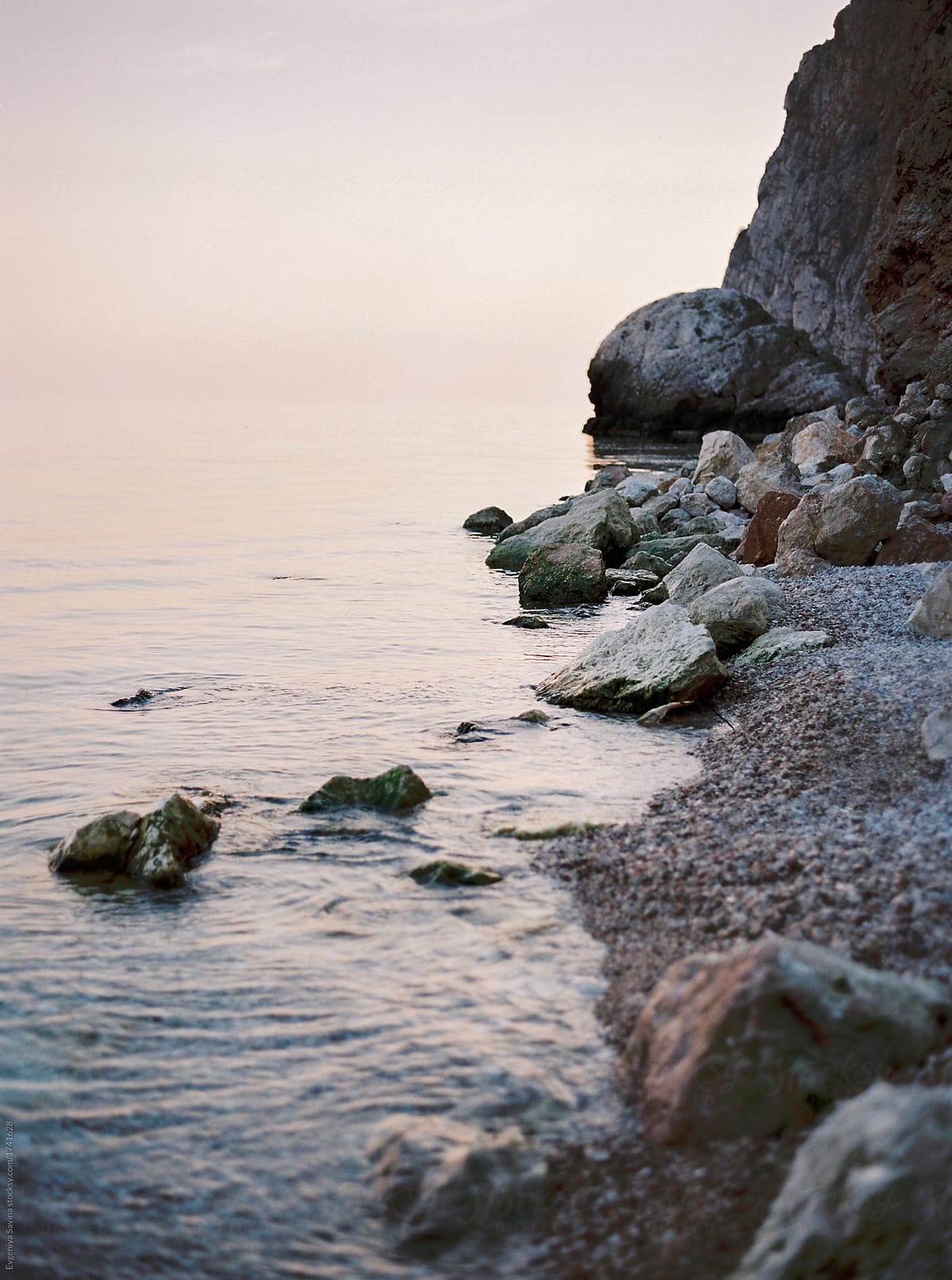 «blue And Pink Sunset Above The Sea With Rocks Coloured In Pink Because