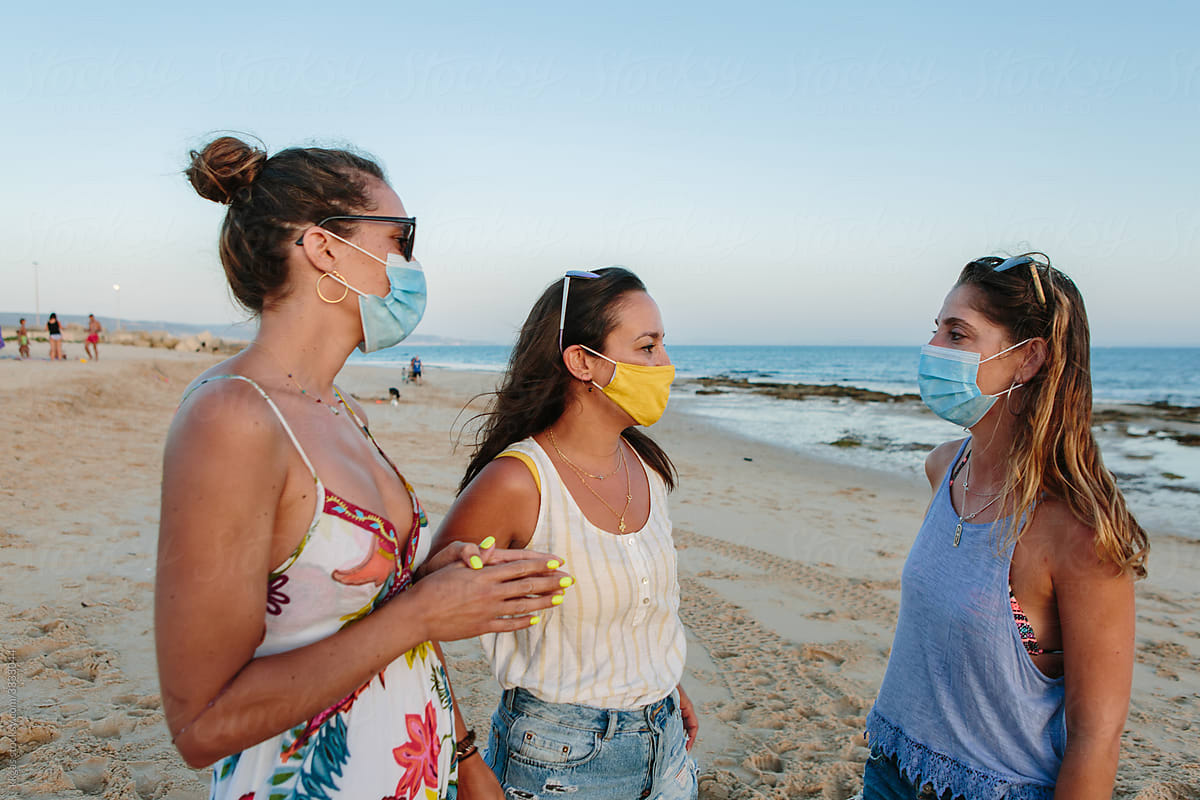 Chatting on the beach with masks