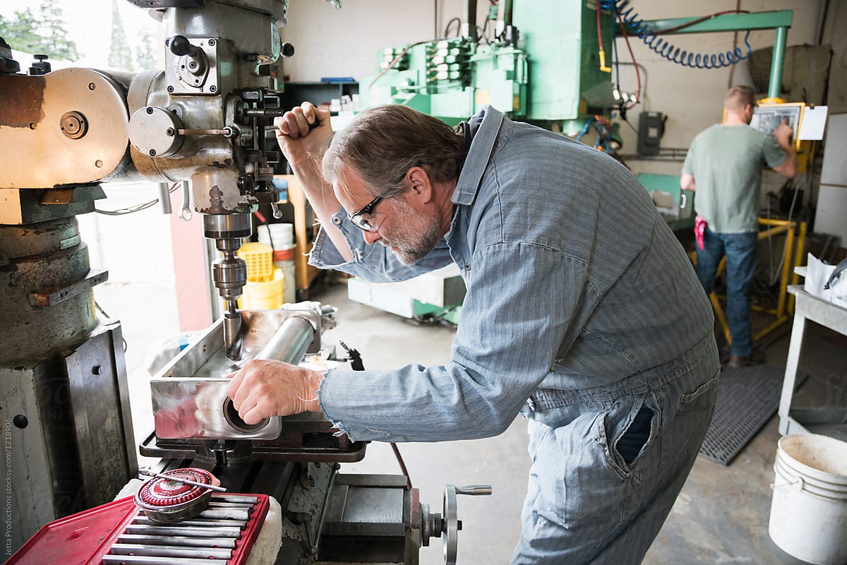 Factory worker using drill press