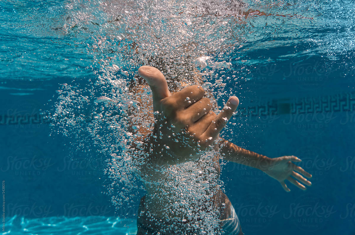 Person gesturing in pool