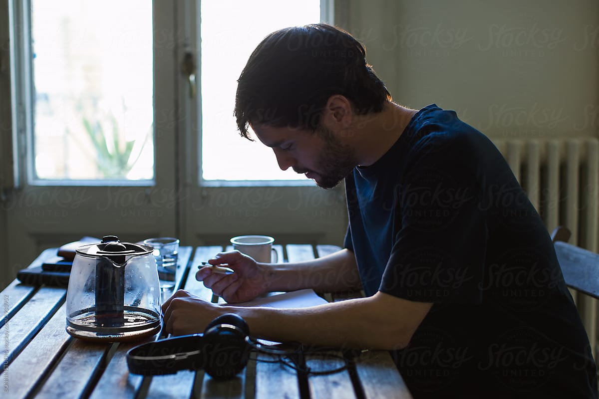 Actor taking notes in script at home.